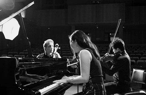Ying Ho playing chamber music at the piano in recital