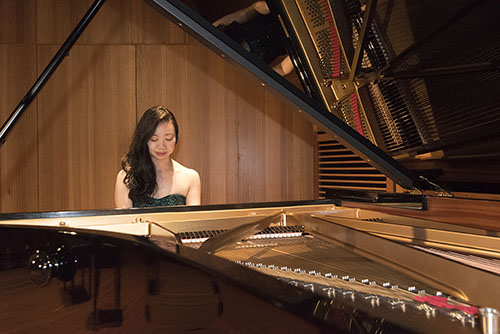 Ying Ho at the keyboard of a grand piano